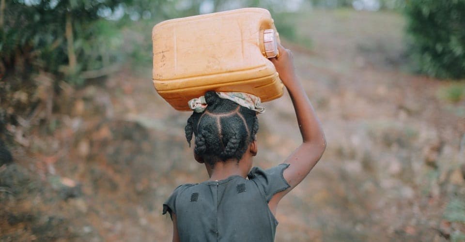 A child carrying water in a Nigerian community