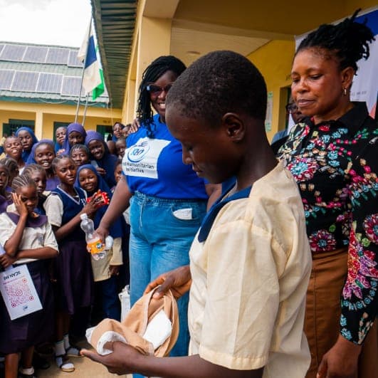 Students receiving supplies at a Pads & Pals distribution